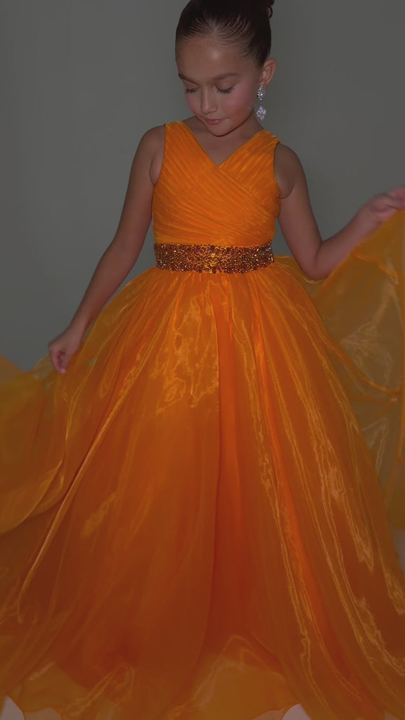 Video - ASHLEYlauren 8249 kids ball gown featuring a V-neckline, ruched bodice, crystal beaded waistline, and a full organza A-line skirt for a graceful and elegant look.